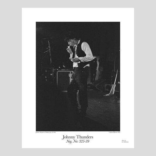 Johnny Thunders lighting a cigarette on stage. The Revenge Tour at Draken, Sweden, Jun 18, 1984. Photography by Johan Ödmann. Rock Lumiere Editions offer beautiful Rock Photography Posters and Limited Edition Fine Art Prints.  Choose among unique b/w photographs of legendary artists and bands.  Order today. Worldwide shipping.